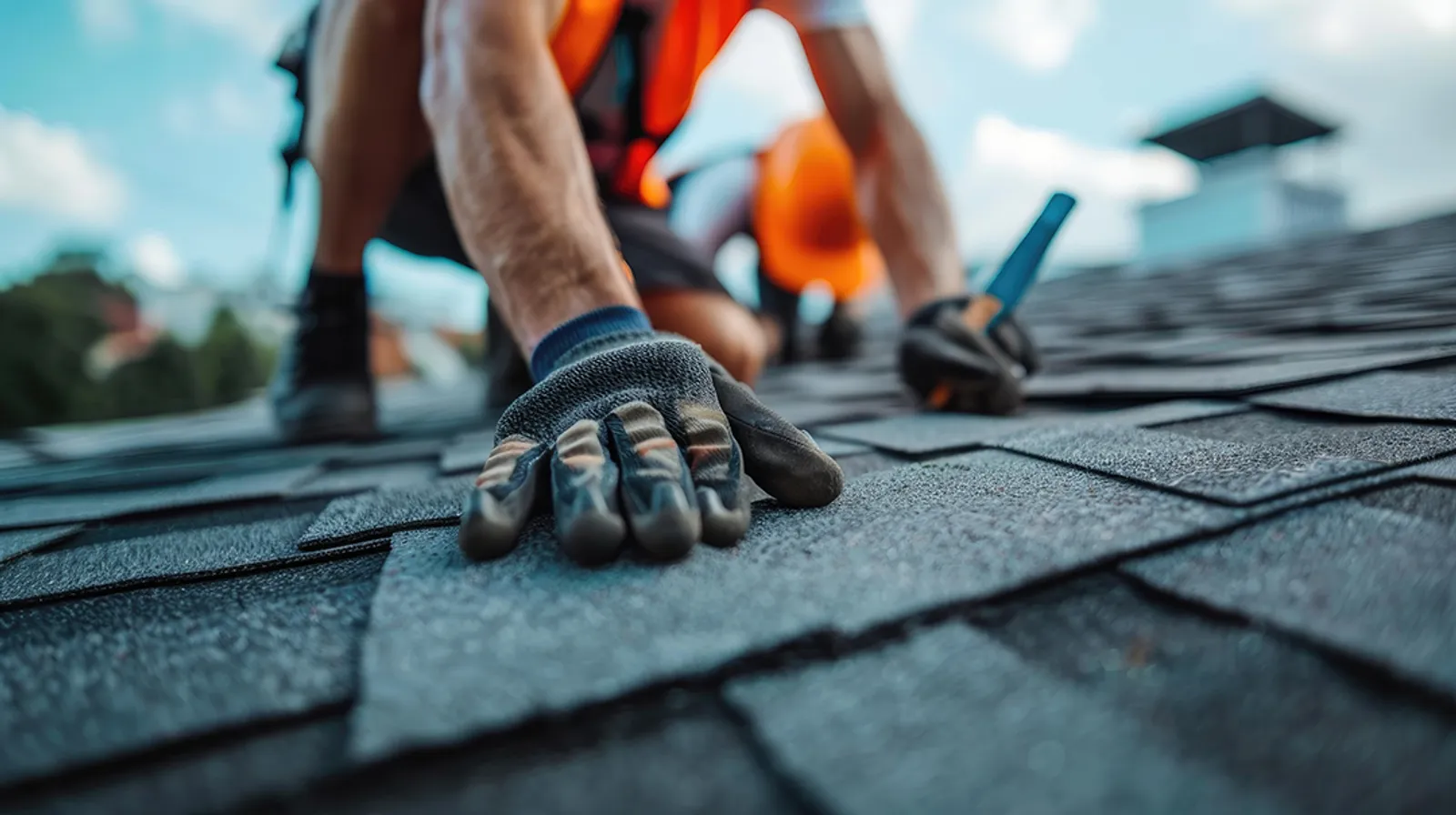 Roofer laying shingles in sequence across a roof deck